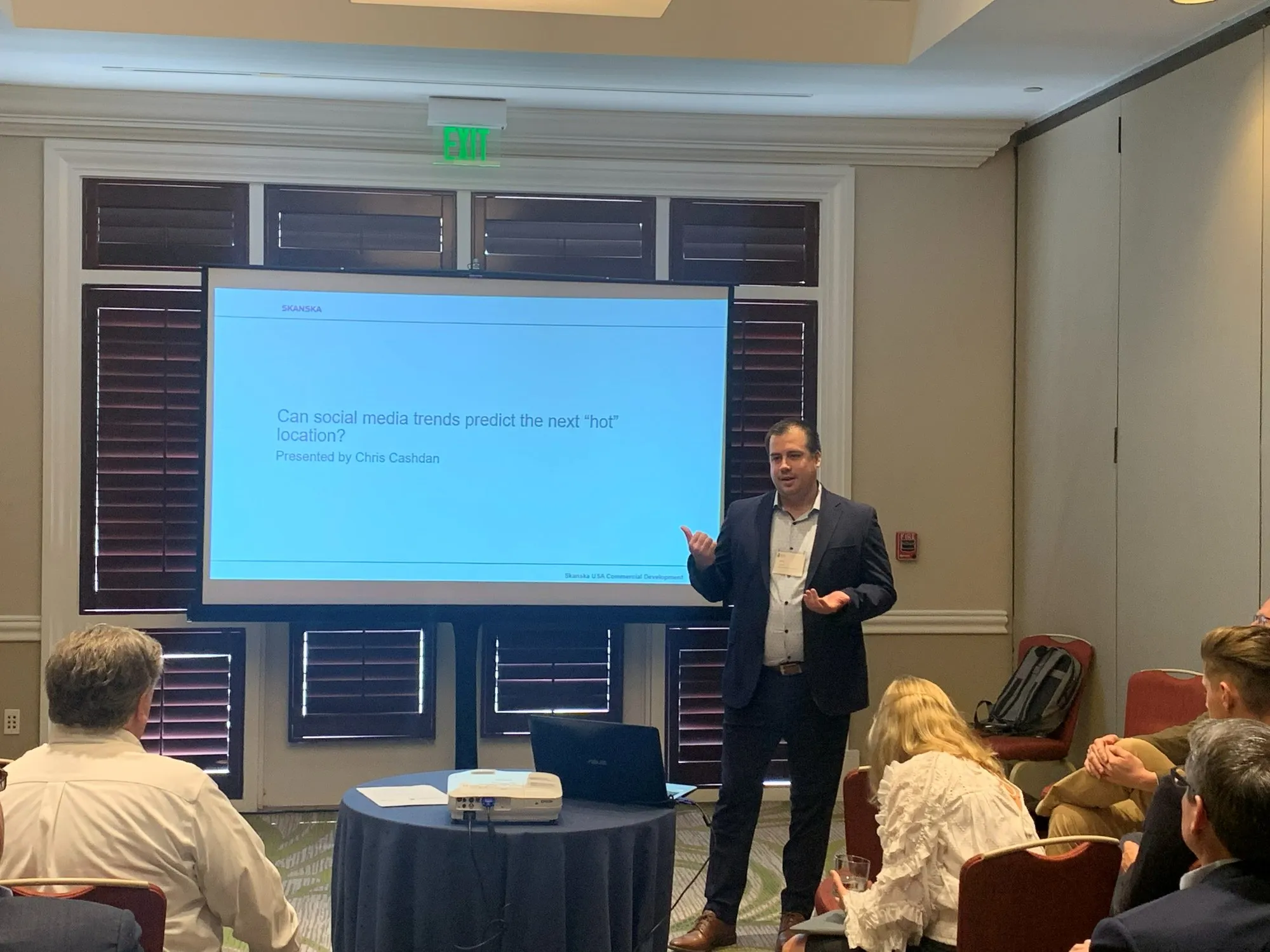 Chris presenting at the ARES Conference in front of the title slide: Can social media trends predict the next hot location?